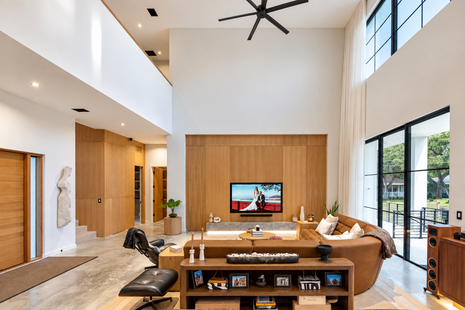 Tampa home living room with custom walnut media-wall cabinetry and display shelves