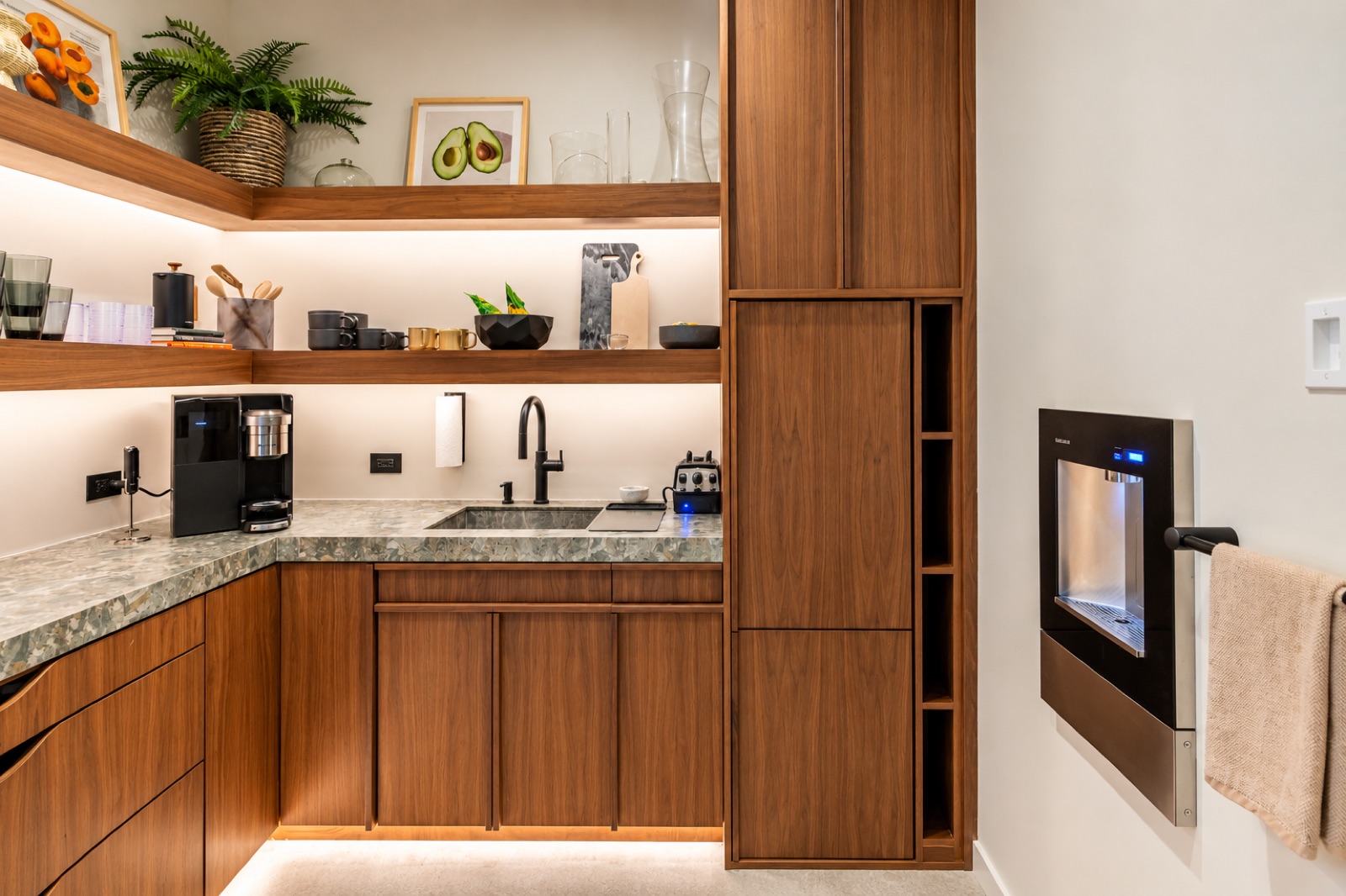 Detailed Tampa home scullery with walnut cabinets, a stone counter, sink, and integrated water station