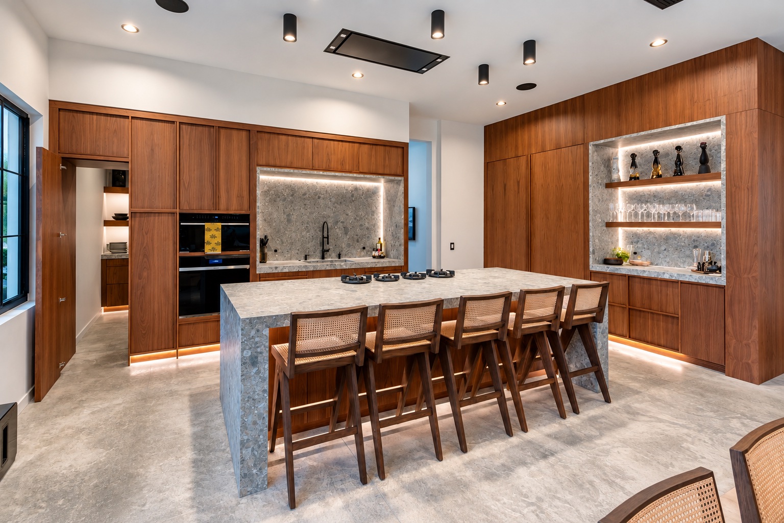 Tampa home kitchen with walnut cabinetry, a stone island, and integrated bar shelving